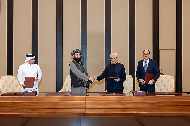 Afghan Defence Minister Mullah Mohammad Yaqoob (second from left) and Pakistan’s Defence Minister Khawaja Muhammad Asif exchange greetings after agreeing to a ceasefire deal mediated by Qatar and Turkey.