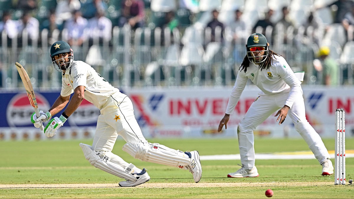 Pakistan's captain Shan Masood (L) watches the ball after playing a shot as South Africa's Tony de Zorzi reacts during the first day of the second Test cricket match between Pakistan and South Africa at the Rawalpindi Cricket Stadium in Rawalpindi on 20 October, 2025