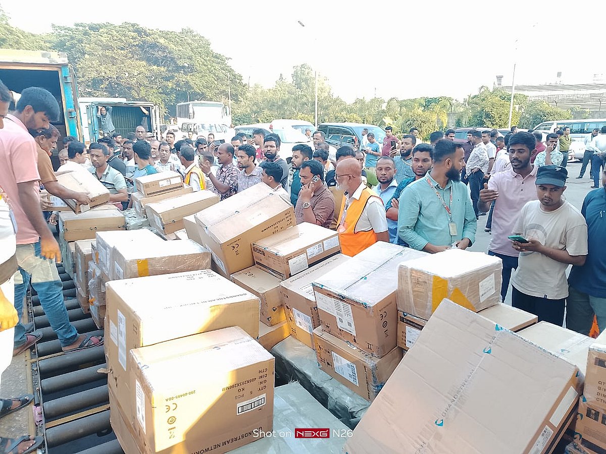 Unscathed goods are offloaded from the debris of fire at Shahjalal International Airport on 20 October