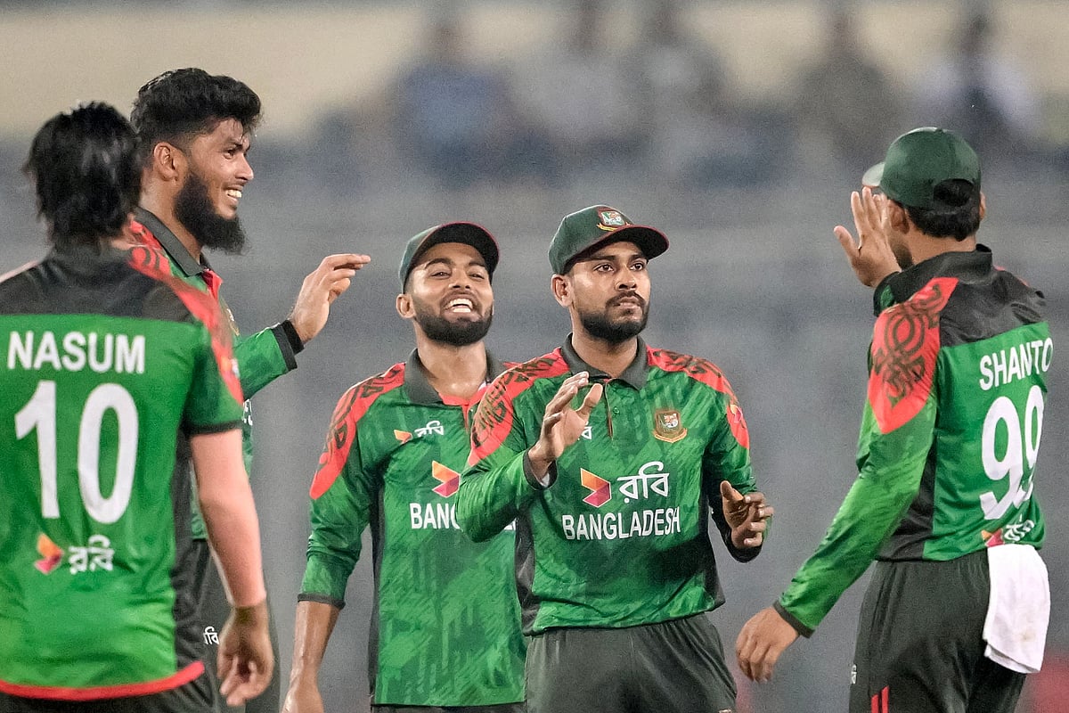 Bangladesh's Rishad Hossain (L) celebrates with teammates after taking the wicket of West Indies' Sherfane Rutherford during the third one-day international (ODI) cricket match between Bangladesh and West Indies at the Sher-e-Bangla National Cricket Stadium in Dhaka on October 23, 2025