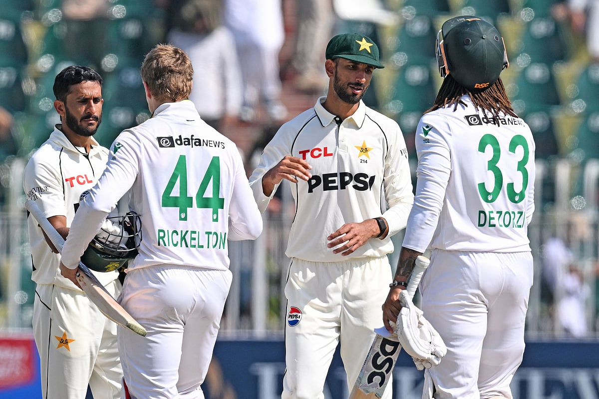 Pakistan's Shan Masood (2R) and his teammate Hasan Ali (L) shake hands with South Africa's Ryan Rickelton (2L) and Tony de Zorzi at the end of the second Test cricket match between Pakistan and South Africa at the Rawalpindi Cricket Stadium in Rawalpindi on 23 October, 2025