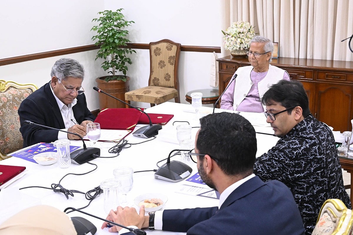 Labour and employment as well as shipping adviser Brigadier General (retd) M Sakhawat Hussain signs the instruments of ratification on behalf of the government in the presence of chief adviser professor Muhammad Yunus at the State Guest House Jamuna on 22 October 2025