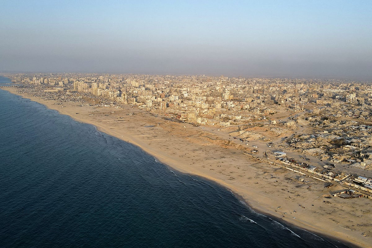 This aerial picture shows the coastal Al-Rashid road next to destroyed buildings in Gaza City's Al-Remal neighbourhood on 23 October, 2025.