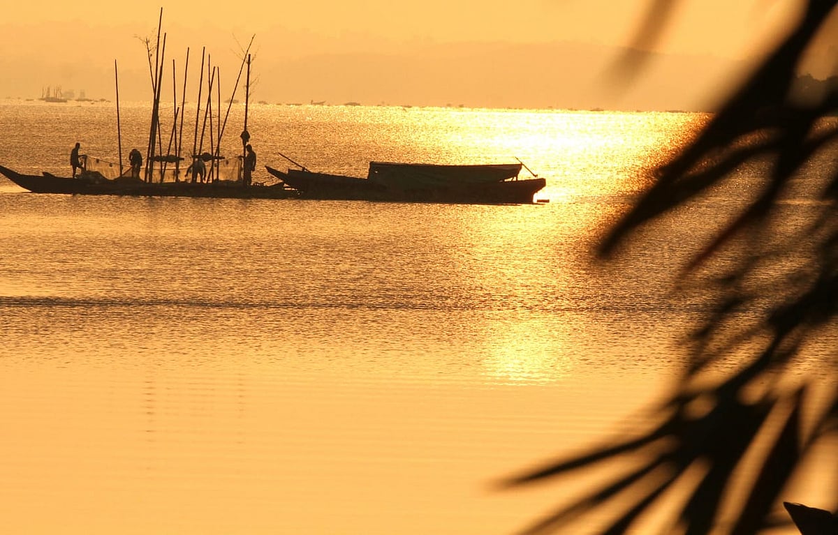 The lake water shimmering in multiple colours at sunrise.