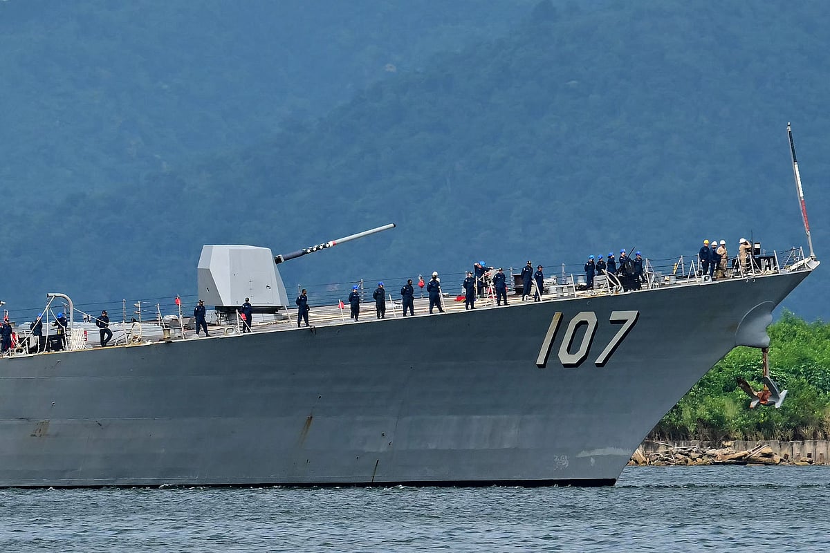 Crew of the USS Gravely warship stand on the bow of the vessel as it enters the port of Port of Spain on 26 October 2025. The US warship will visit Trinidad and Tobago for joint exercises near the coast of Venezuela amid Washington's campaign against alleged drug traffickers in the region.