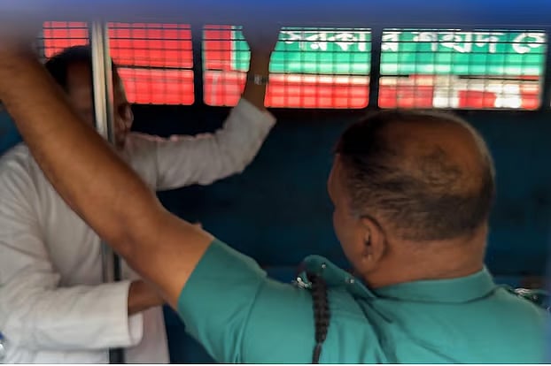 Inside the prison van, Hasanul Haq Inu was asked by police officers to sit down when he tried to speak to his relatives waiting outside while standing. This led to an exchange of words between him and the officers  in front of the Dhaka Metropolitan Sessions Judge Court on 27 October 2025