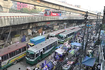 Shops and buses crowd the road near Jatrabari intersection, entry point to Dhaka.