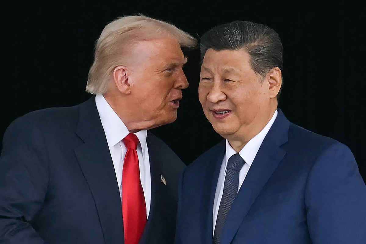 US President Donald Trump (L) talks to China's President Xi Jinping as they shake hands after their talks at the Gimhae Air Base, located next to the Gimhae International Airport in Busan on 30 October 2025.