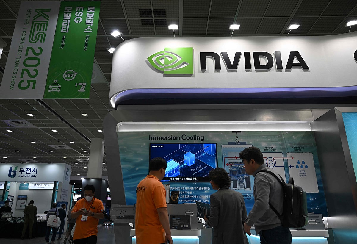 Visitors walk past the logo of NVIDIA during the Korea Electronics Show 2025 at the COEX convention and exhibition centre in Seoul on 22 October 2025.