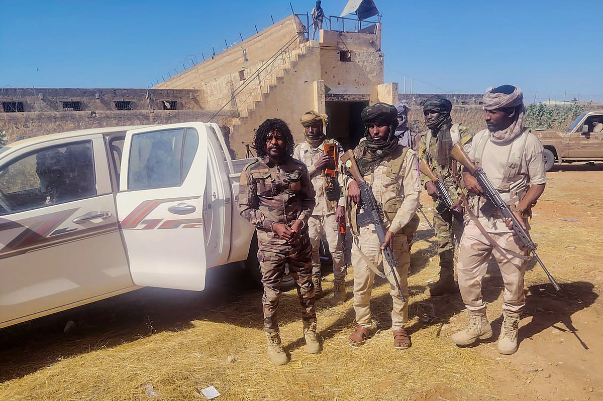 This handout picture released by the Sudanese Rapid Support Forces (RSF) on October 30, 2025, shows RSF members reportedly detaining a fighter known as Abu Lulu (L) in El-Fasher, in war-torn Sudan’s western Darfur region