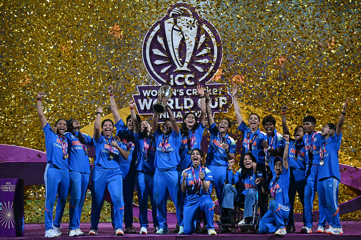 India’s players celebrate with the trophy after winning the ICC Women's Cricket World Cup 2025 one-day international (ODI) final match between India and South Africa at the DY Patil Stadium in Navi Mumbai on 3 November, 2025.