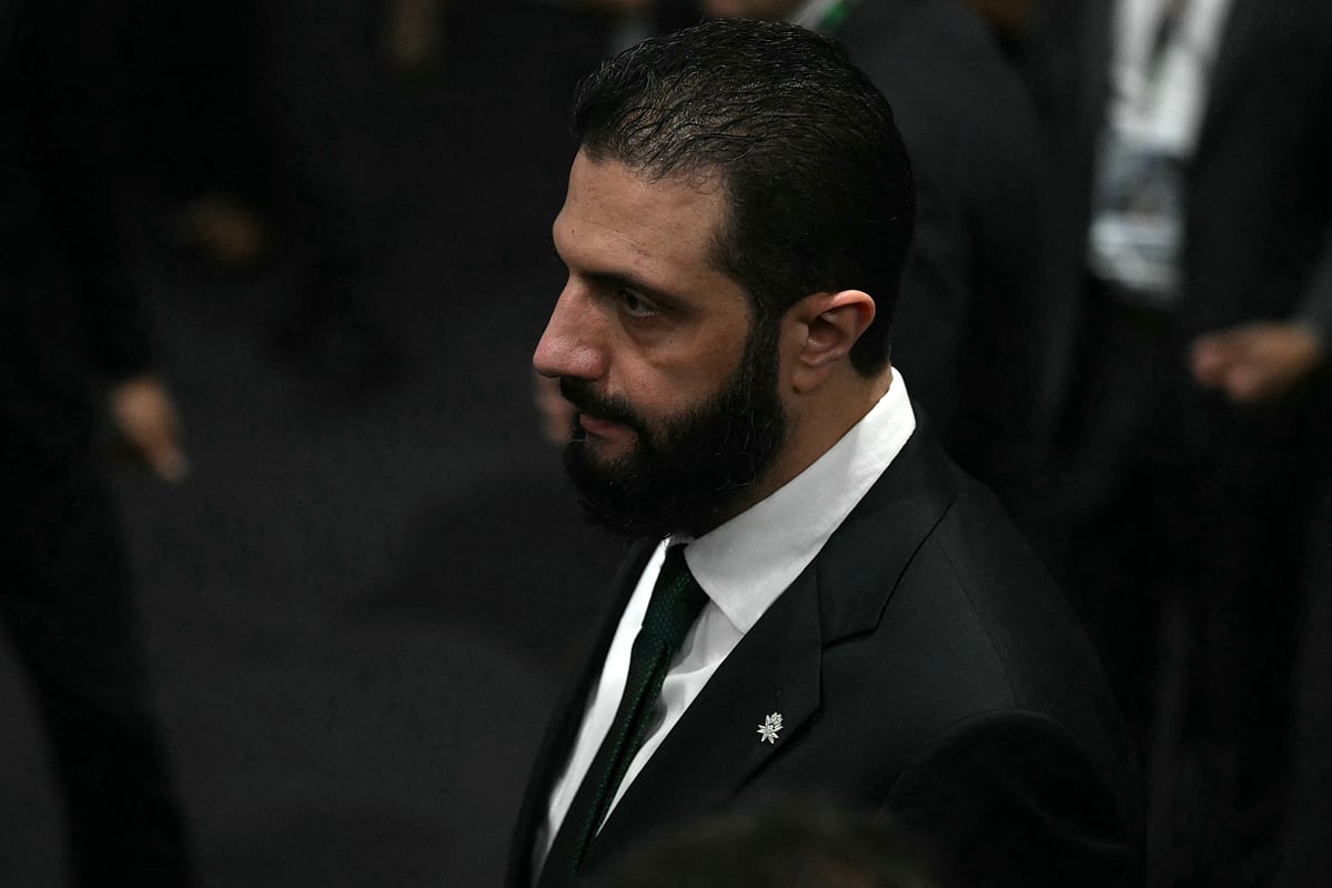 Syria's President Ahmad Al Sharaa walks on arrival at the General Plenary of Leaders in the framework of the COP30 UN Climate Change Conference in Belem, Para State, Brazil, on 6 November, 2025.