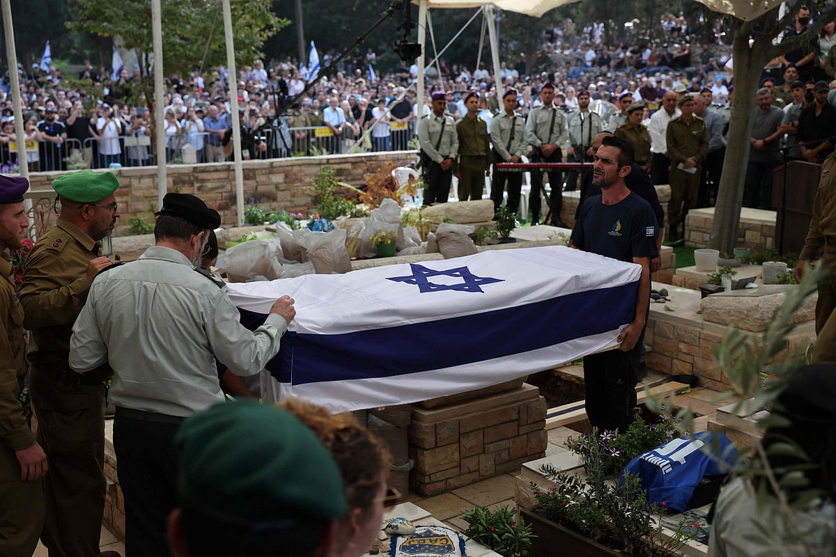 Israeli soldiers attend to the coffin of Lieutenant Hadar Goldin, who was killed during the six-week 2014 war in Gaza, at his funeral in a military cemetery in Kfar Saba on 11 November, 2025