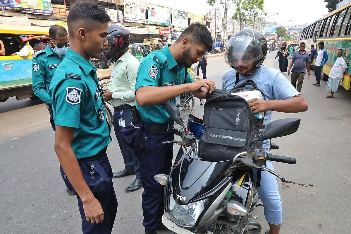 Police search the bag of a biker in Babu Bazar Bridge area on 10 November