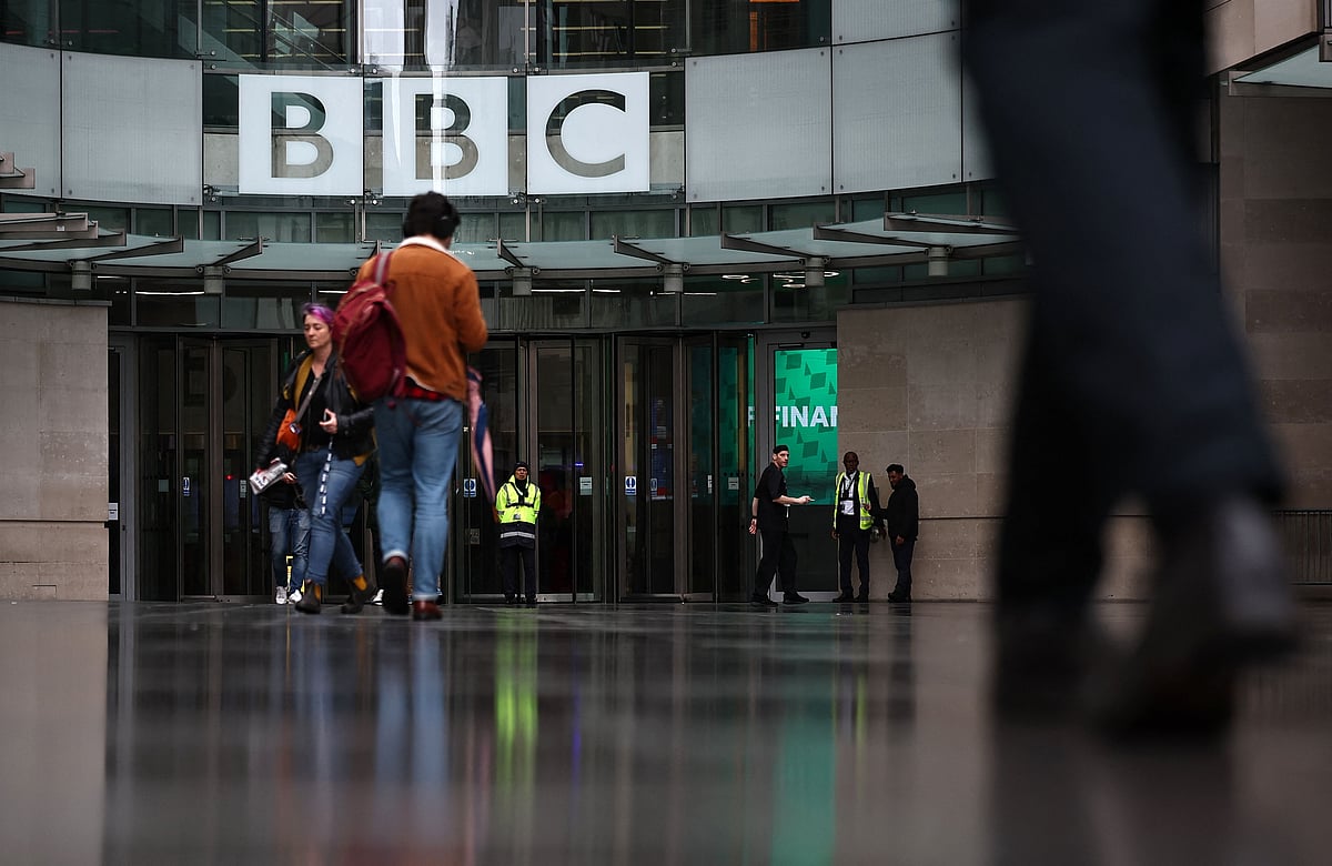 People are pictured outside the entrance to the BBC in London on 10 November 2025