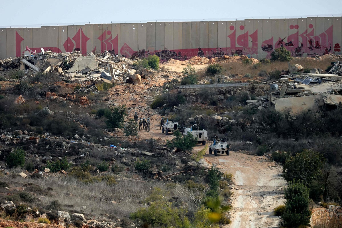 Troops from the United Nations Interim Force in Lebanon (UNIFIL) patrol near the southern Lebanese border village of Kfar Kila on 12 November 2025