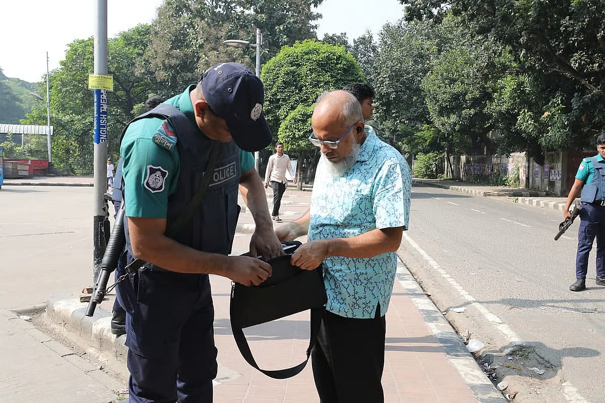 Police search bag of an elderly person at the entrance to Dhanmondi 32, Dhaka on 13 November 2025.