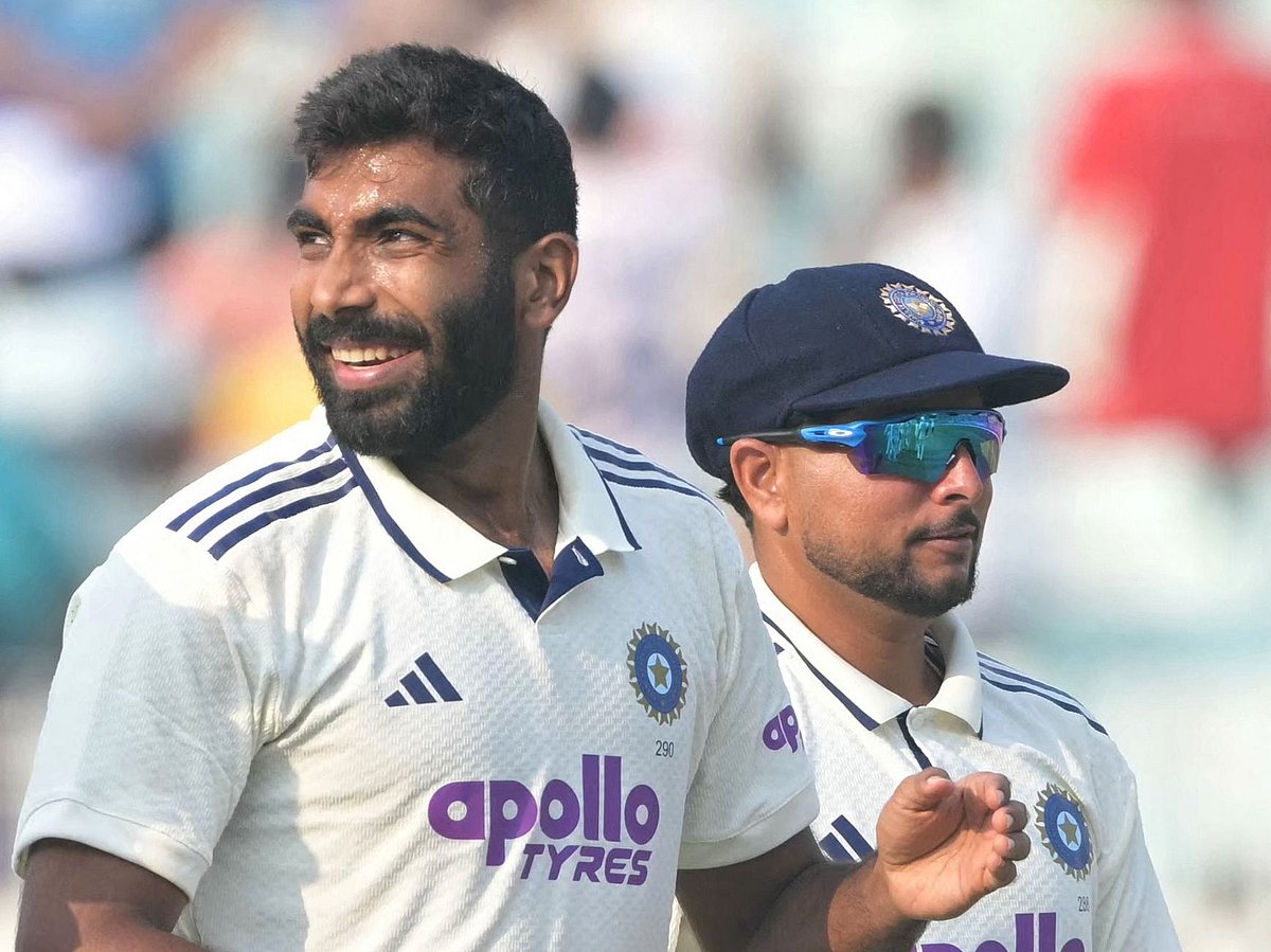 India's Jasprit Bumrah and Kuldeep Yadav celebrate after taking wickets during the first day of the first Test cricket match between India and South Africa at the Eden Gardens in Kolkata on 14 November, 2025.
