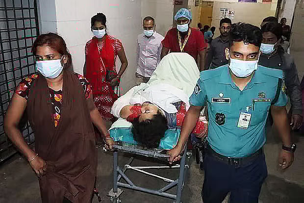 Tasnim Nahar, the wife of a judge who was injured in the attack, is being taken from the operating room to the ward. At Rajshahi Medical College Hospital on 13 November, 2025