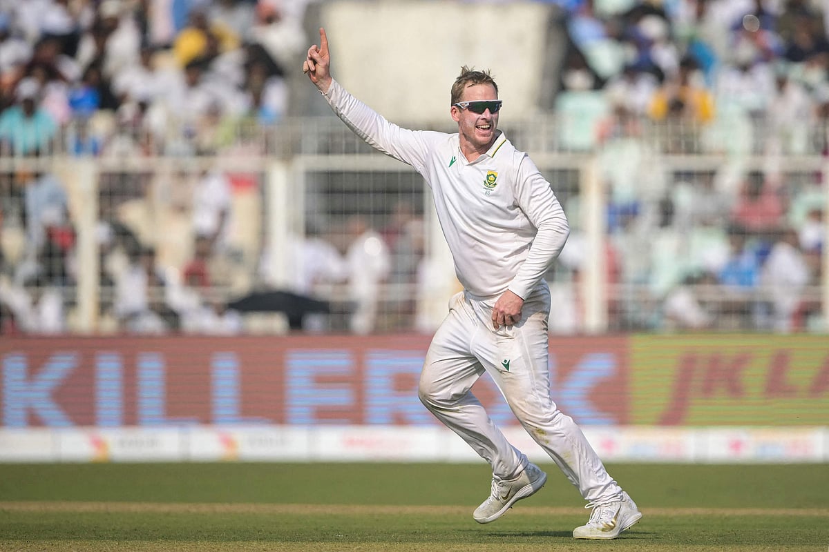 South Africa's Simon Harmer celebrates after taking the wicket of India's Kuldeep Yadav during the third day of the first Test cricket match between India and South Africa at the Eden Gardens in Kolkata on 16 November, 2025