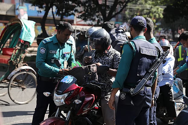 Police search the bags of passengers arriving on motorcycles. Monday, Dhanmondi