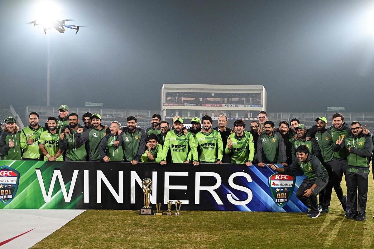 Pakistan's players and team officials pose with trophy at the end of the third one-day international (ODI) cricket match between Pakistan and Sri Lanka at the Rawalpindi Cricket Stadium, in Rawalpindi, on 16 November, 2025.