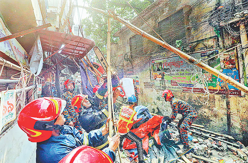 Fire Service personnel conduct rescue operations after three pedestrians were killed when the roof railing of a building collapsed during the earthquake in Kasaituli, Bangshal, Old Dhaka, on 21 November 2025.