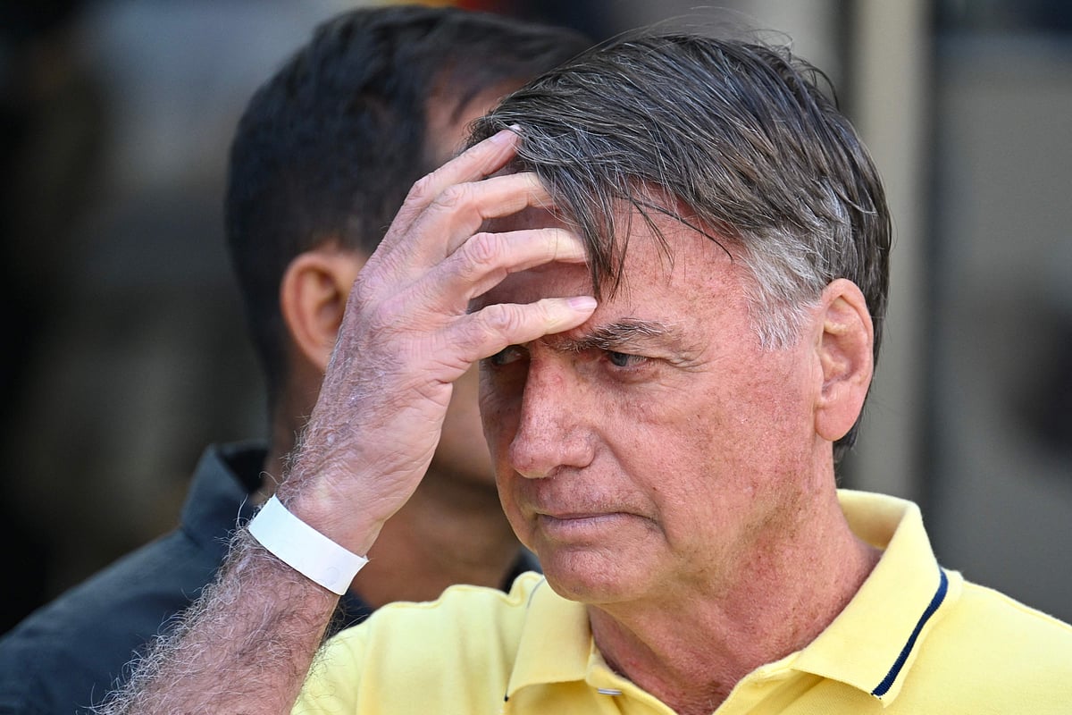 Former Brazilian President Jair Bolsonaro gestures after taking medical tests at DF Star hospital in Brasilia on August 16, 2025. Former Brazilian president Jair Bolsonaro, sentenced to 27 years in prison for attempted coup, was placed in pre-trial detention on 22 November, 2025, according to his lawyer and a source close to the case