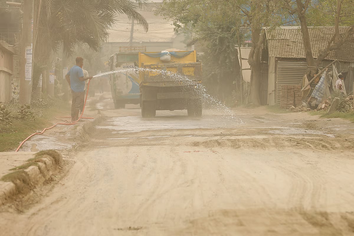 Water is being sprayed on the road to reduce dust. The photo was taken recently from the Khan Jahan Ali Bridge area in Khulna.