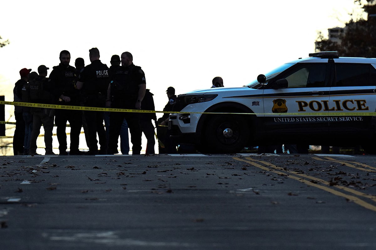Law-enforcement officials visit the crime scene of a shooting in downtown Washington, DC, on 26 November 2025