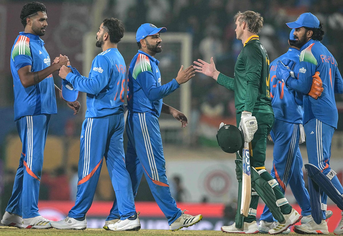 South Africa’s Corbin Bosch (2R) shakes hands with India’s Rohit Sharma (C) at the end of the first one-day international (ODI) cricket match between India and South Africa at the JSCA International Stadium in Ranchi on 30 November 2025