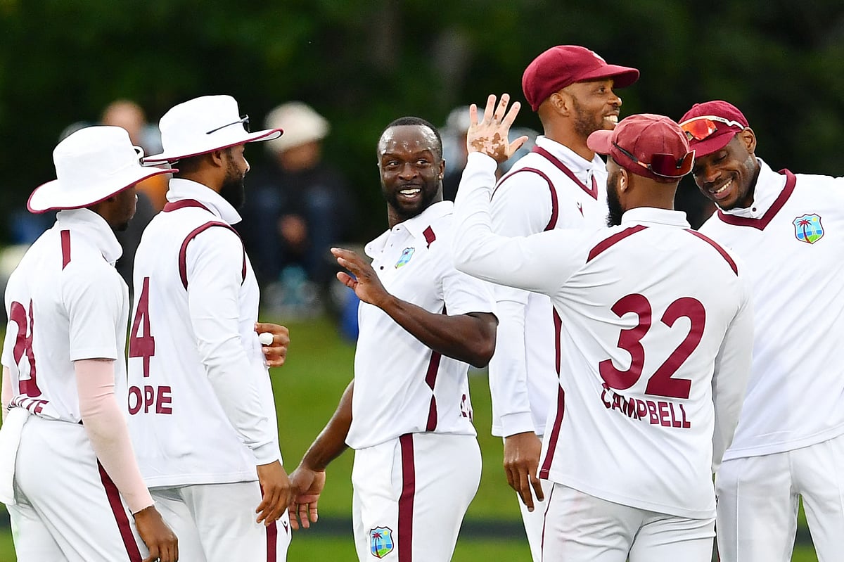 West Indies’ Kemar Roach (C) celebrates the wicket of New Zealand’s Matt Henry with his teammates during day one of the first Test cricket match between New Zealand and West Indies at Hagley Oval in Christchurch on 2 December 2025