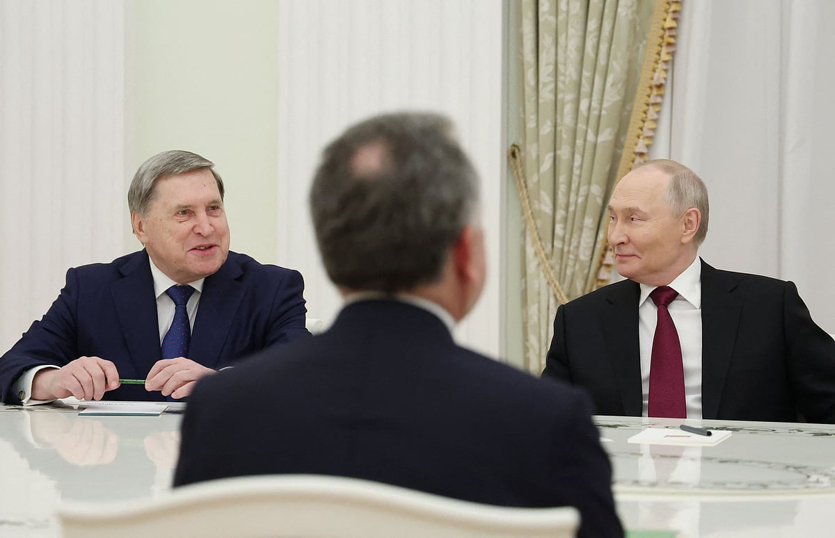 In this pool photograph distributed by the Russian state agency Sputnik, Russia’s President Vladimir Putin and Kremlin aide Yuri Ushakov attend a meeting with US special envoy Steve Witkoff at the Kremlin in Moscow on 2 December 2025