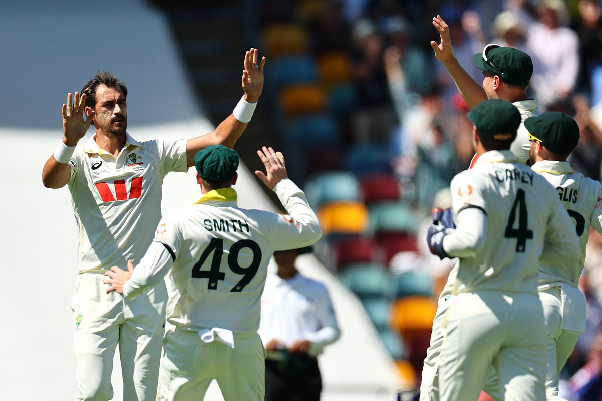 Australia's Mitchell Starc (L) celebrates the wicket of England's Zak Crawley on day one of the second Ashes cricket Test match between Australia and England at The Gabba in Brisbane on 4 December 2025