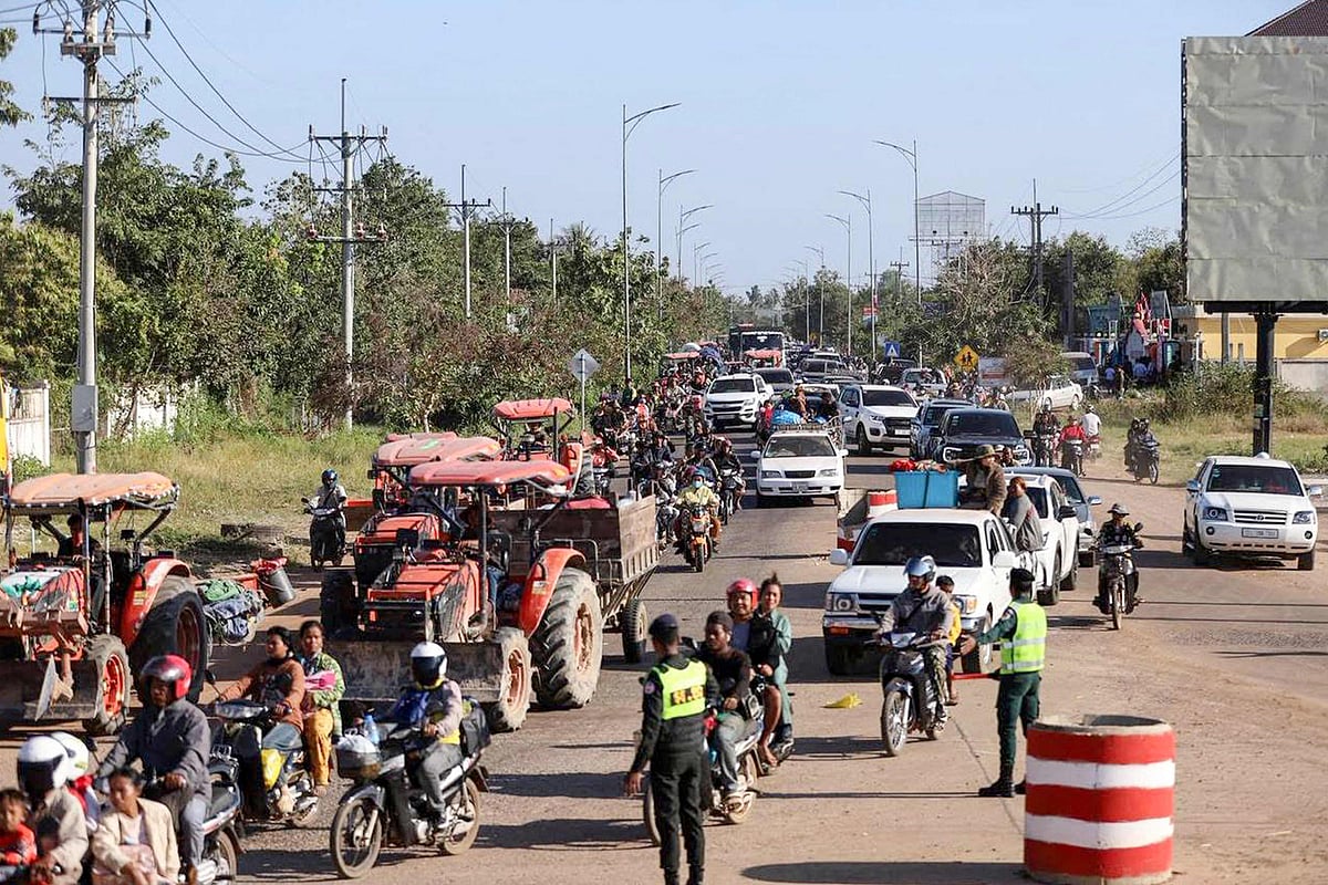 This handout photo taken and released by Agence Kampuchea Press (AKP) on December 8, 2025 shows local residents evacuating following clashes along the Cambodia-Thailand border in Oddar Meanchey province