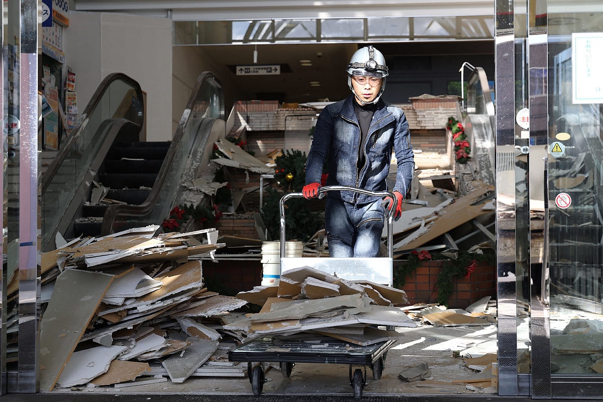 A worker clears debris at a shopping center damaged by the earthquake in Hachinohe City, Aomori Prefecture on 9 December 2025