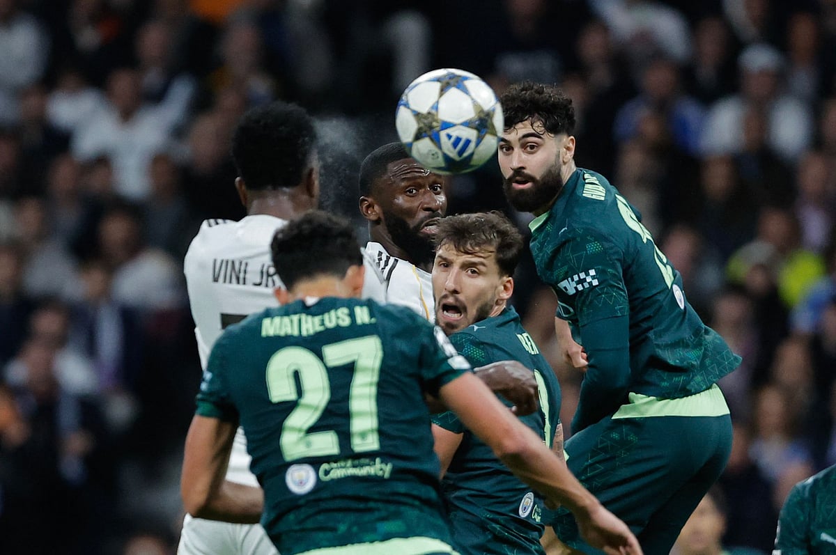 Manchester City's Croatian defender #24 Josko Gvardiol (C) and Real Madrid's German defender #22 Antonio Ruediger go for a header during the UEFA Champions League league phase day 6 football match between Real Madrid CF and Manchester City at Santiago Bernabeu Stadium in Madrid on 10 December, 2025.