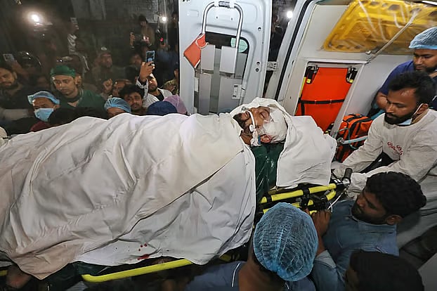 Osman Hadi being placed in an ambulance to be taken to Evercare Hospital in the capital. Photo taken at Dhaka Medical College Hospital Friday night
