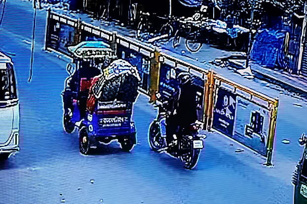 Person on back of motorcycle shoots Osman Hadi sitting in a battery-run rickshaw. The assailants sped on the motorcycle