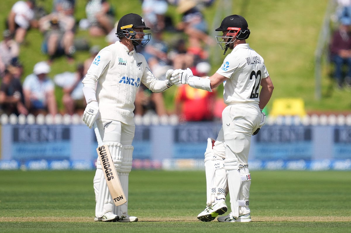 New Zealand's Devon Conway (L) celebrates a four with teammate Kane Williamson during day three of the 2nd international Test cricket match between New Zealand and West Indies at the Basin reserve in Wellington on 12 December, 2025.