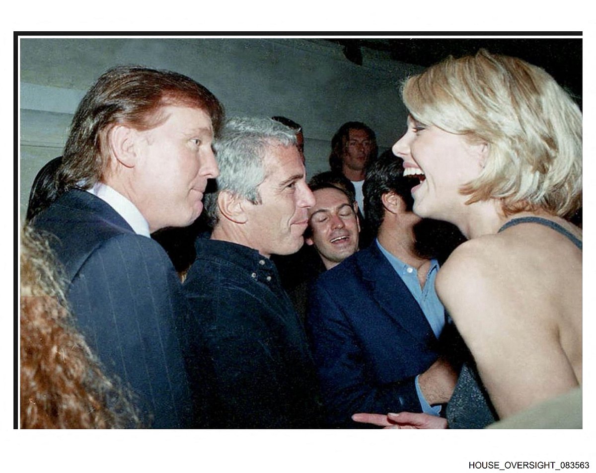 This undated photo from the personal collection of Jeffrey Epstein provided by the Democrats on the House Oversight Committee on 12 December 2025, shows US President Donald Trump (L), flanked by Epstein (C), talking to an unknown woman.