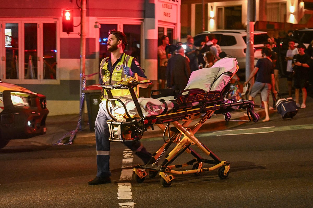 A health worker moves a stretcher after a shooting incident at Bondi Beach in Sydney on December 14, 2025. Australian police said two people were in custody following reports of multiple gunshots on December 14 at Sydney's famed Bondi Beach, urging the public to take shelter