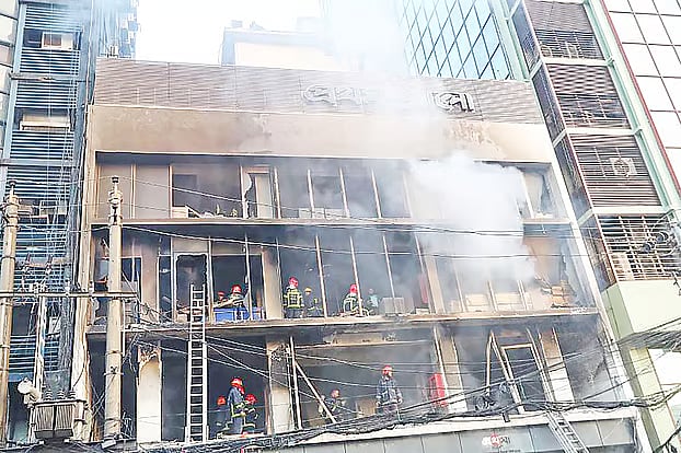 Miscreants attacked, looted and set fire to the Prothom Alo office on 18 December. Fire service men are extinguishing the fire.