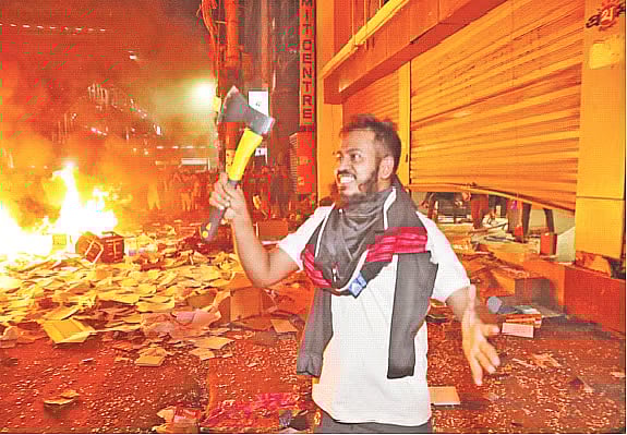 One of the attackers involved in the assault celebrating while holding an axe.