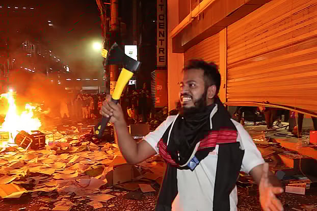 Mainul Islam brandishing an axe during attack on Prothom Alo