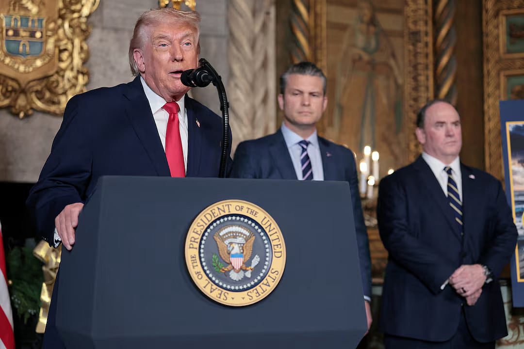 US President Donald Trump makes an announcement about the Navy's "Golden Fleet", as Secretary of Defense Pete Hegseth and Secretary of the Navy John Phelan listen, at Mar-a-lago in Palm Beach, Florida, US, 22 December, 2025.