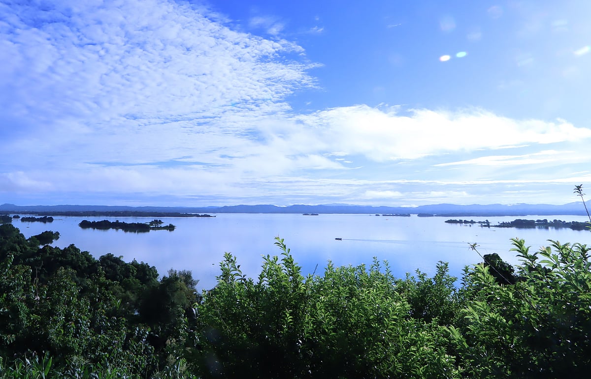 The blue sky, clouds and the waters of Kaptai lake appear to merge into a single scene.