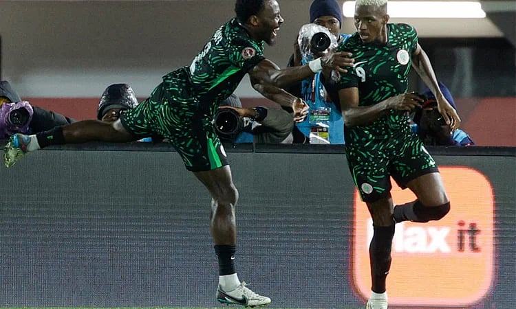 Nigeria's Victor Osimhen celebrates his goal with Nigeria's defender Bright Osayi-Samuel during the Africa Cup of Nations (CAN) Group C football match between Nigeria and Tunisia at Fez Stadium in Fez on 27 December, 2025.