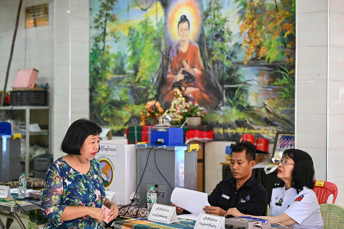 A woman arrives to vote at a polling station during the first phase of Myanmar's general election in Yangon on 28 December, 2025.