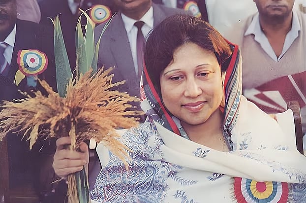 Khaleda Zia holding up election symbol, sheaf of paddy. Photo taken in 1991